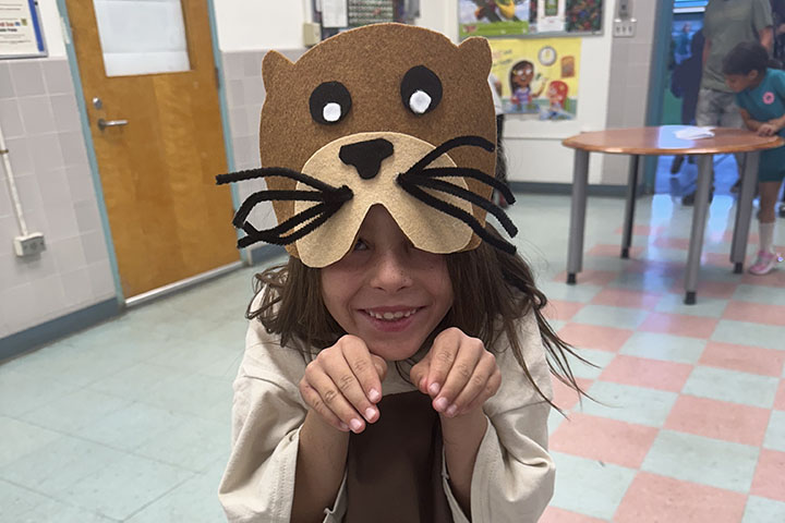 A student dressed up as a beaver poses for a photo