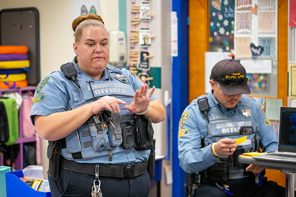 A woman and man dressed in community service officer uniforms