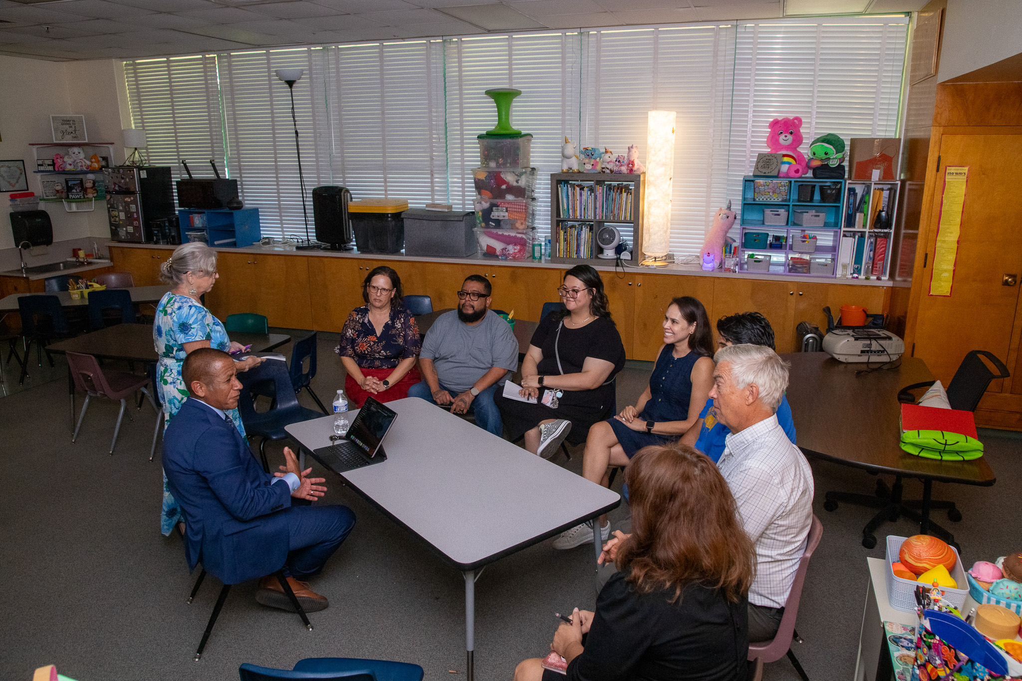 Dr.Trujillo talks to a group of teachers sitting around a table